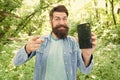 Man bearded wanderer walking in forest with navigation application. Hiking with navigation app. Route for exciting