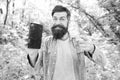 Man bearded wanderer walking in forest with navigation application. Hiking with navigation app. Route for exciting