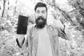 Man bearded wanderer walking in forest with navigation application. Route for exciting adventure. GPS and navigation