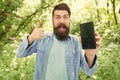 Man bearded wanderer walking in forest with navigation application. Route for exciting adventure. GPS and navigation