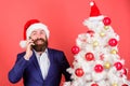 Man bearded wear suit and santa hat hold phone. Manager congratulate colleagues mobile call. Make christmas magic with