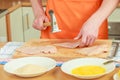 Man beating chicken meat on wooden board Royalty Free Stock Photo