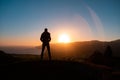 Man in beautiful inspiring sunrise with mountains and sea. Royalty Free Stock Photo