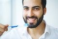 Man With Beautiful Smile, Healthy White Teeth With Toothbrush. H Royalty Free Stock Photo