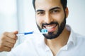 Man With Beautiful Smile, Healthy White Teeth With Toothbrush. H Royalty Free Stock Photo