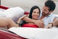 Man and beautiful woman hugging in cabriolet car Royalty Free Stock Photo