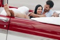 Man and beautiful woman hugging in cabriolet car Royalty Free Stock Photo