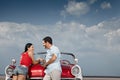 Man and beautiful woman leaning on cabriolet car Royalty Free Stock Photo