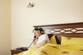 Man in bed calling by phone Royalty Free Stock Photo