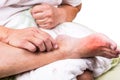 Man on bed embrace foot with painful swollen gout inflammation