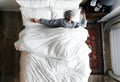 Man on bed sleeping with an eye cover Royalty Free Stock Photo