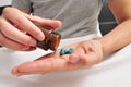 Man in bed about to take some blue pills Royalty Free Stock Photo