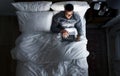 Man on bed using his laptop Royalty Free Stock Photo