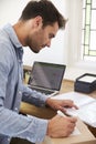 Man In Bedroom Running Business From Home Labeling Goods