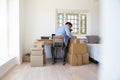 Man In Bedroom Running Business From Home Labeling Goods