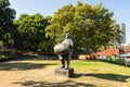 Man with beer barrel or statue of a beer coach in the city garden in Dortmund, North Rhine-Westphalia, Germany