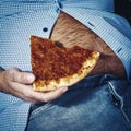 Man with a beer belly eating pizza Royalty Free Stock Photo