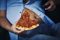 Man with a beer belly eating pizza Royalty Free Stock Photo