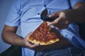 Man with a beer belly eating pizza Royalty Free Stock Photo