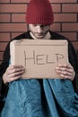 Man begging on the street with help sign Royalty Free Stock Photo