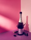 Man, behind a bottle of sparkling wine with arms and legs raised. Doll. Pink violet background. Text space. Party, celebration.