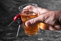 Man behind car key and glass of liqueur Royalty Free Stock Photo