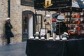 Man behind hats on sale at a stall inside Spitalfields Market, London, UK Royalty Free Stock Photo