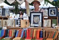 A man behind his stall selling books with a secret