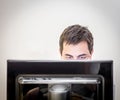 Man behind the monitor of a desk computer Royalty Free Stock Photo