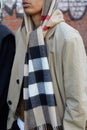 Man with beige trench coat and checkered scarf before Fendi fashion show, Milan Fashion Week