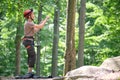 Man belays his partner climber with belaying device and rope. Climber`s handsman holding equipment for rock mountaineering