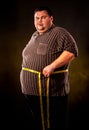 Man belly fat with tape measure weight loss around body . Royalty Free Stock Photo