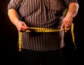 Man belly fat with tape measure weight loss around body . Royalty Free Stock Photo