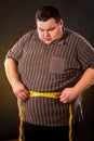 Man belly fat with tape measure weight loss around body . Royalty Free Stock Photo