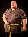 Man belly fat with tape measure weight loss around body . Royalty Free Stock Photo