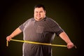 Man belly fat with tape measure weight loss around body . Royalty Free Stock Photo