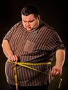 Man belly fat with tape measure weight loss around body . Royalty Free Stock Photo