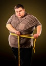 Man belly fat with tape measure weight loss around body . Royalty Free Stock Photo