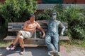 Man on a bench with the sculpture `Lunchbreak` by J. Seward Johnson on Key West. Museum of Art and History sculpture exhibit. Royalty Free Stock Photo