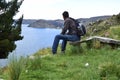 A man on a bench watching the landscape of the Lake Titicaca. Copacabana, Bolivia Royalty Free Stock Photo