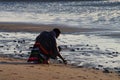 A man on bended knees at the beach Royalty Free Stock Photo