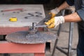 Man bends metal part creating curved shape using special machine. Forge - metal workshop. Royalty Free Stock Photo