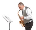 Man bent down playing saxophone on white isolated background Royalty Free Stock Photo