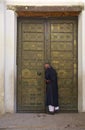 Man in berber clothing knocking on the door Royalty Free Stock Photo