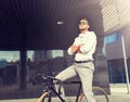 Man with bicycle and headphones on city street Royalty Free Stock Photo