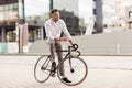 Man with bicycle and headphones on city street Royalty Free Stock Photo