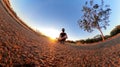 Man with bicycle on little on a park with trees, soft blue sky and sunset. Outdoor dramatic of man with mask in a park and