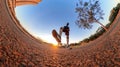 Man with bicycle on little on a park with trees, soft blue sky and sunset. Outdoor dramatic of man with mask in a park and