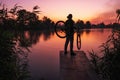 Man with a bicycle on the lookout admires the sunrise or sunset. Sport, active lifestyle. Beautiful colors at dawn Royalty Free Stock Photo