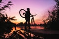 Man with a bicycle on the lookout admires the sunrise or sunset. Sport, active lifestyle. Beautiful colors at dawn Royalty Free Stock Photo